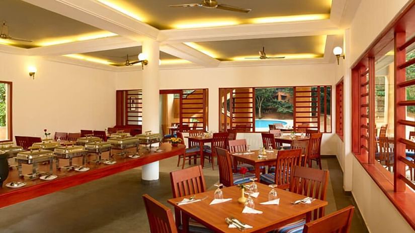 An overview of the seating arrangement inside Peppermint the in-house restaurant - Abad Green Forest, Thekkady.