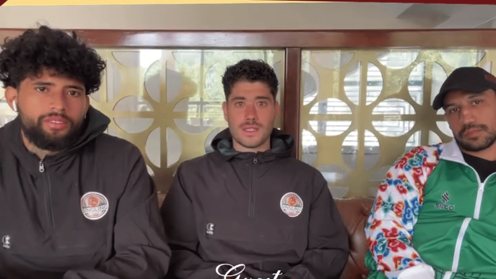 Three men seated together wearing sporty jackets at Avianna Group of Hotels & Resorts, with hotel branding  Luxury That Connects Service - That Cares at the top and contact details, website, and location icons displayed at the bottom. 