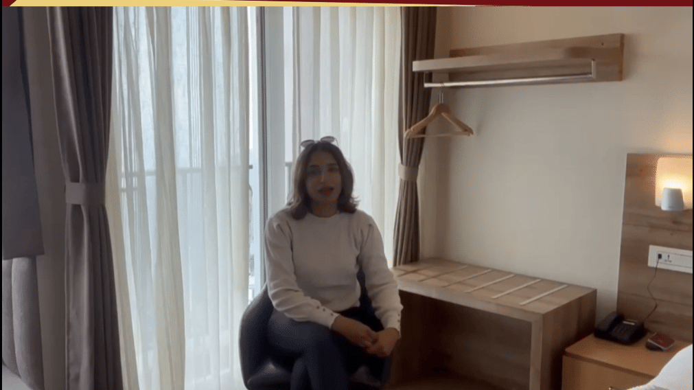A female influencer eated indoors at with Avianna Group of Hotels & Resorts branding  Luxury That Connects Service -That Cares at the top and contact information, website, and location tags displayed at the bottom. 