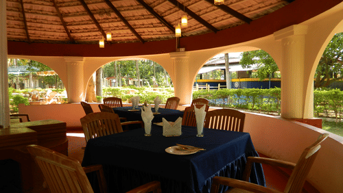 Image of Gazebo Restaurant at Fantasy Golf Resort Bangalore featuring tables and chairs arranged with a green view