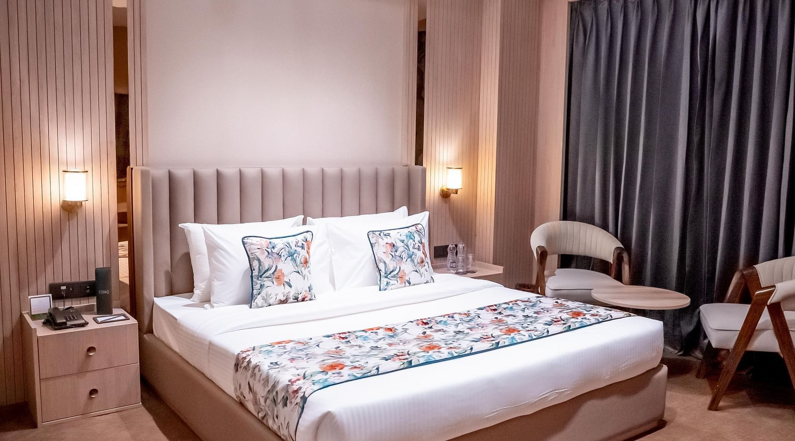 Executive Suite with a bed, bed side tables, chairs and a window with a curtain in the background at ASTER GRAND BY ZENQ SAKET.