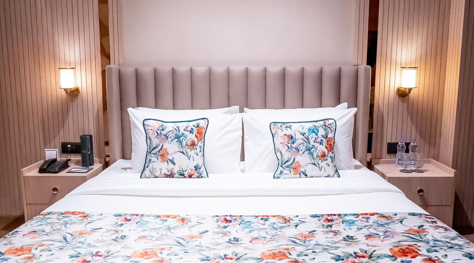 A bed with pillows and two bed side tables on both sides at ASTER GRAND BY ZENQ SAKET.