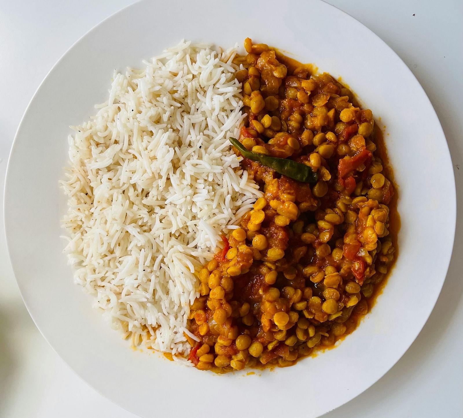 An image of a bowl here rice and lentil soup is served