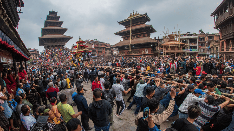 Massive crowds gather around a wooden chariot during the vibrant Bisket Jatra festival at Nyatapola Temple square in Bhaktapur, Nepal.