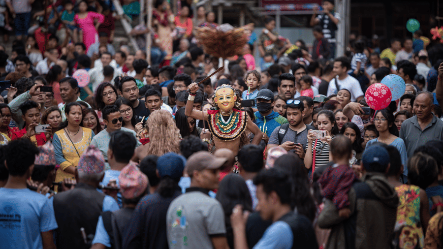 A dense crowd gathering in a public square to celebrate the traditional Newari demon-expelling festival of Ghantakarna in Nepal.