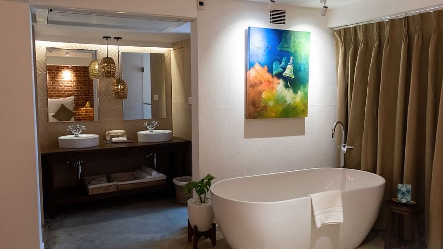 Bathtub, wall hanging and the washroom area at the Nepali Suite - The Nanee