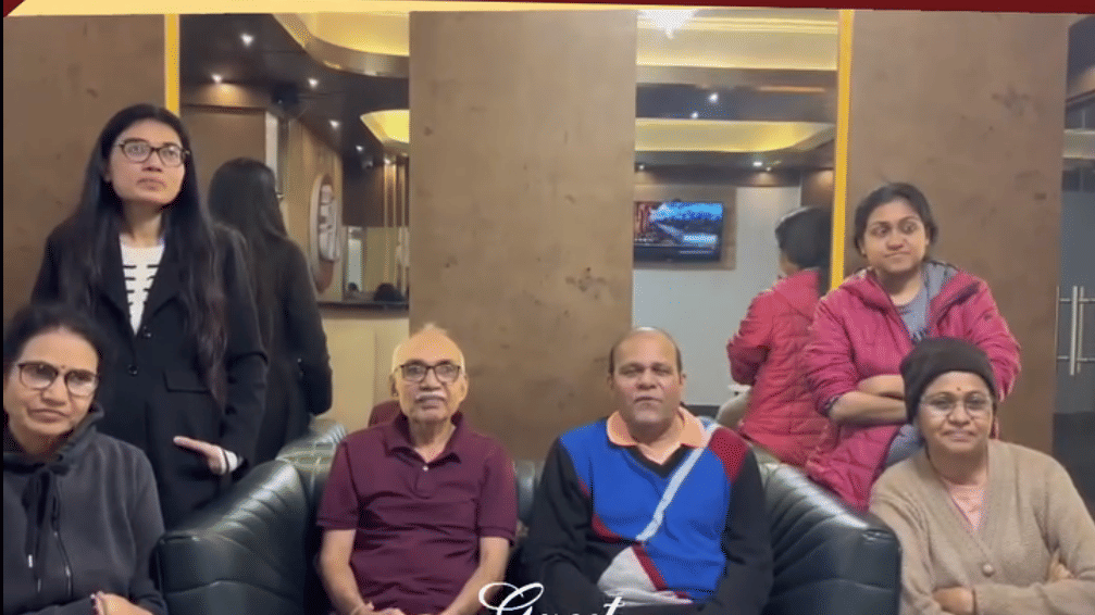 Group of six guests seated in the lobby with the Avianna Group of Hotels & Resorts branding Luxury That Connects Service -That Cares displayed above, hotel contact details and location tags are shown at the bottom.