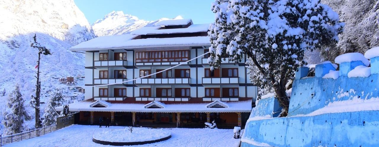A facade image of Yashshree, Lachung where the hotel building and its surrounding is seen to be covered in snow