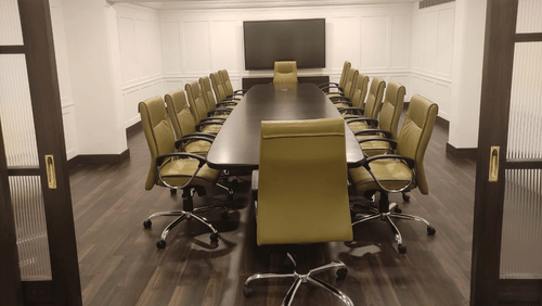 General's Boardroom at Jehan Numa Palace, featuring a modern conference room with a long table, chairs, and TV