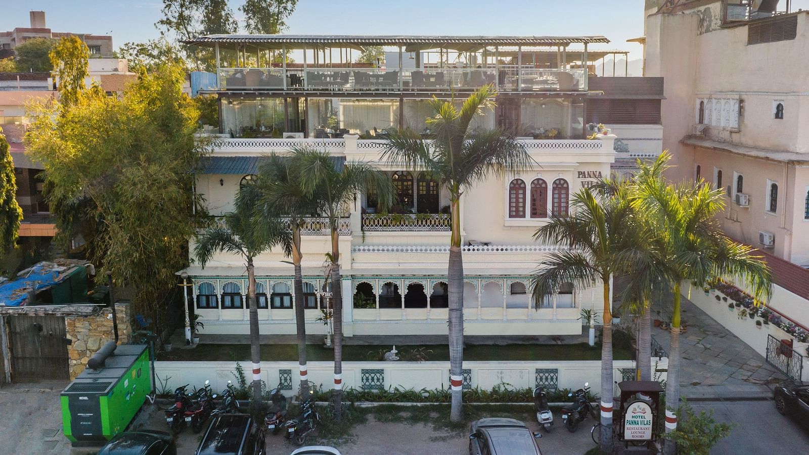 Aerial view of the facade of Panna Vilas Palace, Udaipur, in the morning with cars parked in the front..