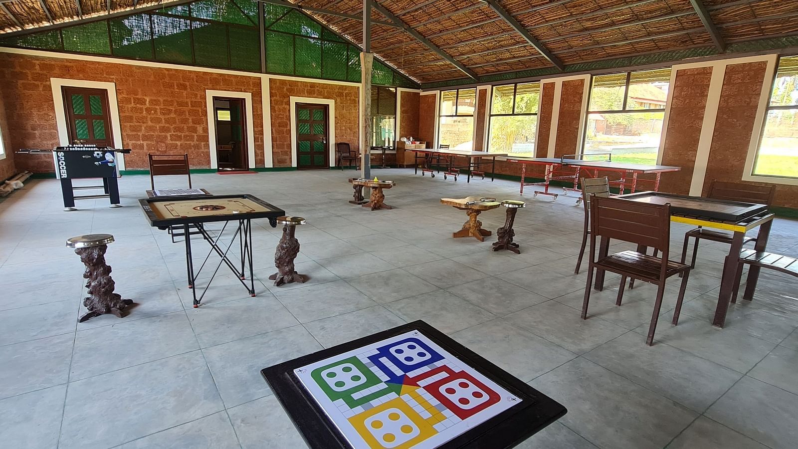 image of the game area with board games like ludo and carom in the activity area at hoysala village resort, hassan