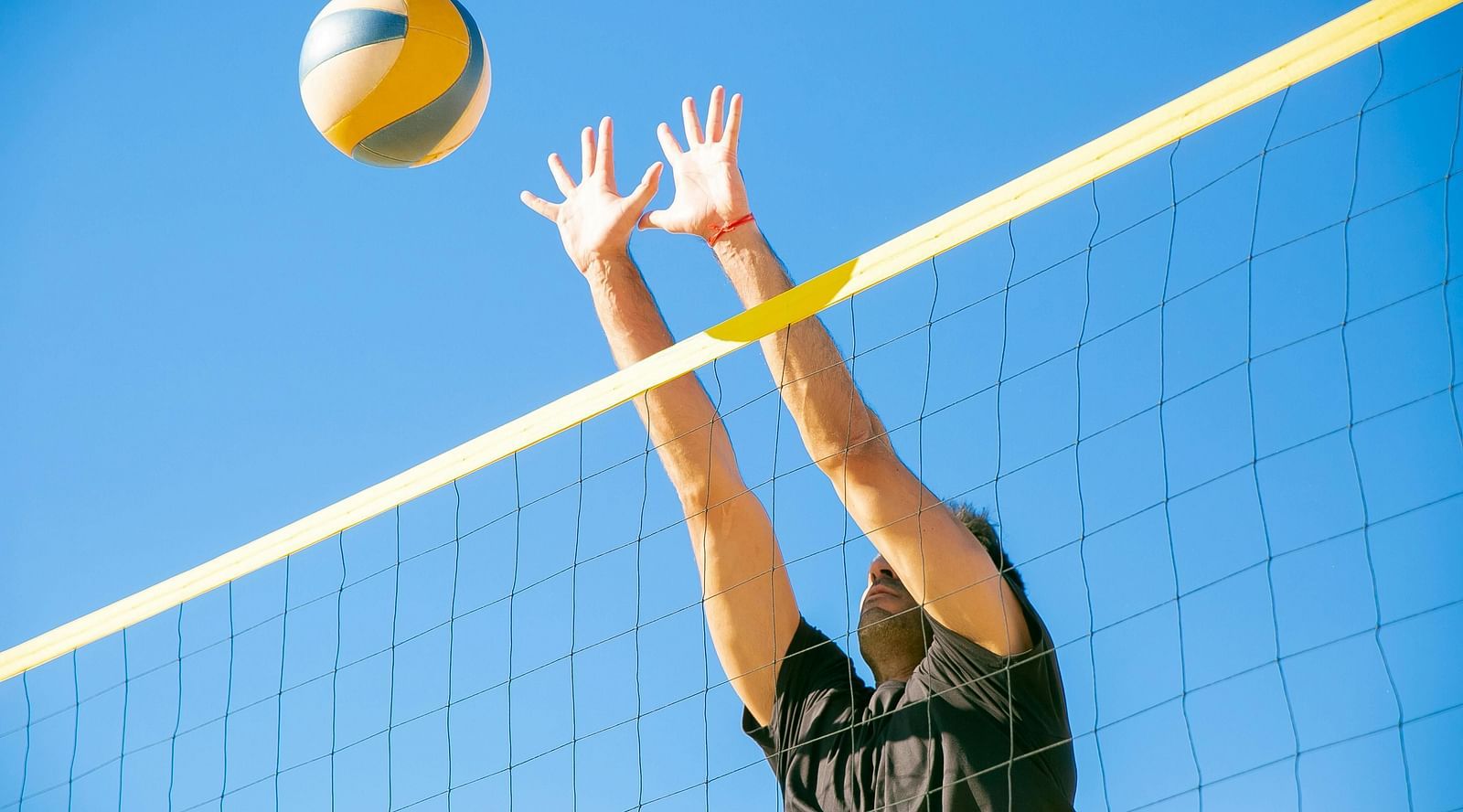 image of a person who is about to hit the volleyball from the other side of the net