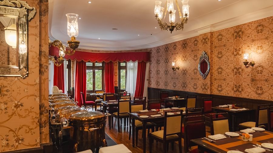 Elegant restaurant with arranged seating and a side buffet at The Claridges Nabha Residence