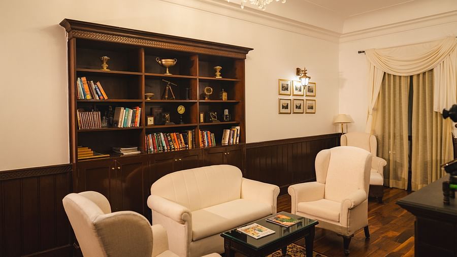 Cozy library area featuring comfortable seating and a refined ambiance at The Claridges Nabha Residence