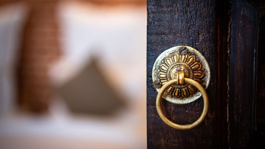  A door with a brass handle that leads into a room at The Nanee.