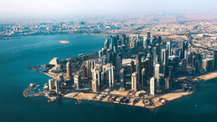 The aerial view of the city of Doha with the sea next to it. To know what to see in Doha in 2 days, visit the popular attractions.