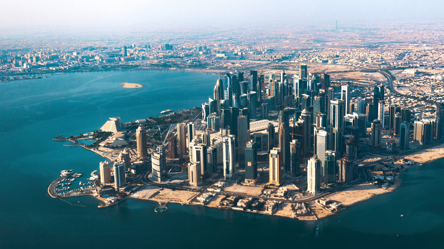 The aerial view of the city of Doha with the sea next to it. To know what to see in Doha in 2 days, visit the popular attractions.