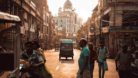people crossing a road near a market in Lucknow