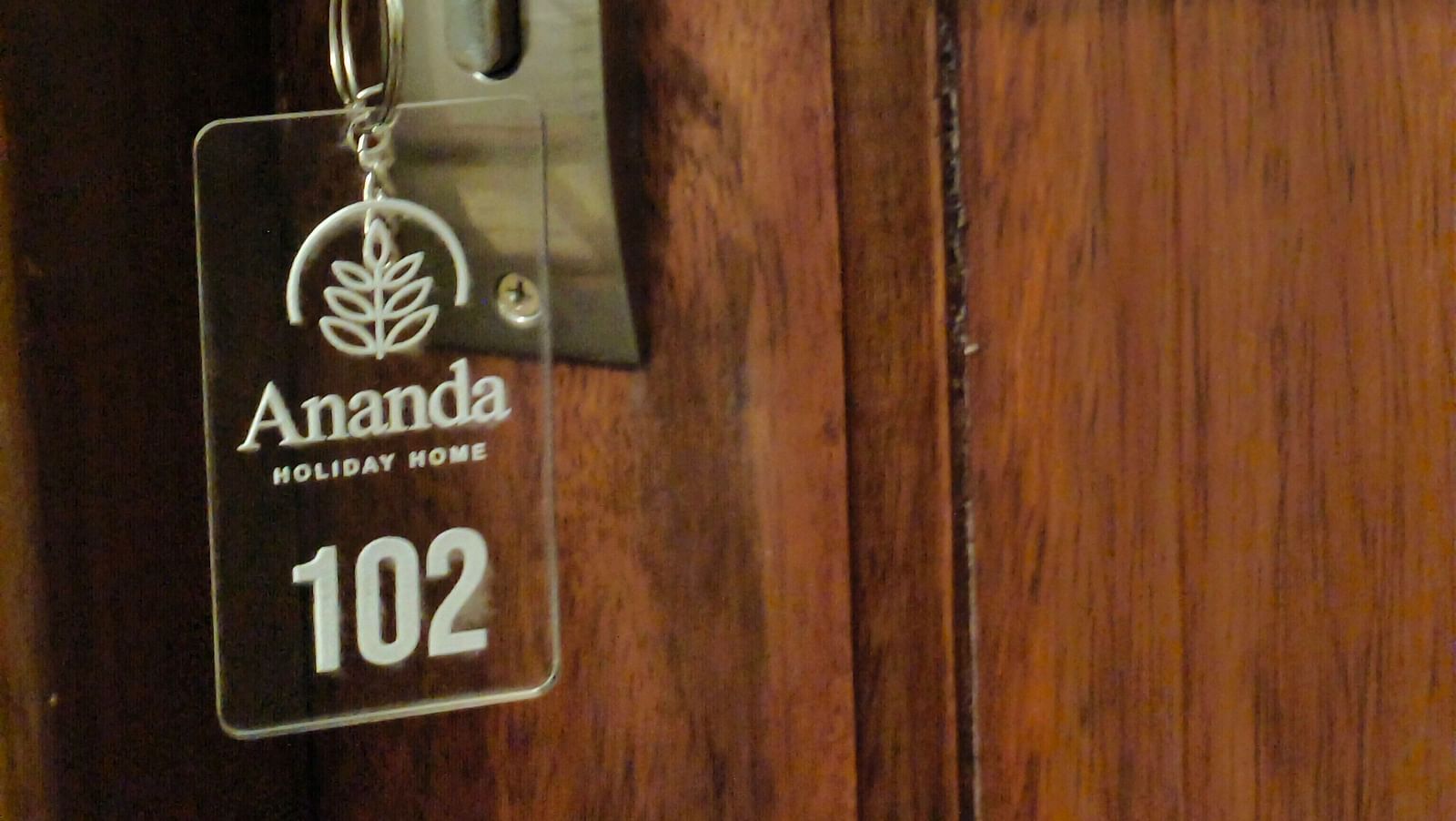A Key with the key chain saying room 102 hanging on the door of 102 room at Ananda Holiday Home, Wayanad 1