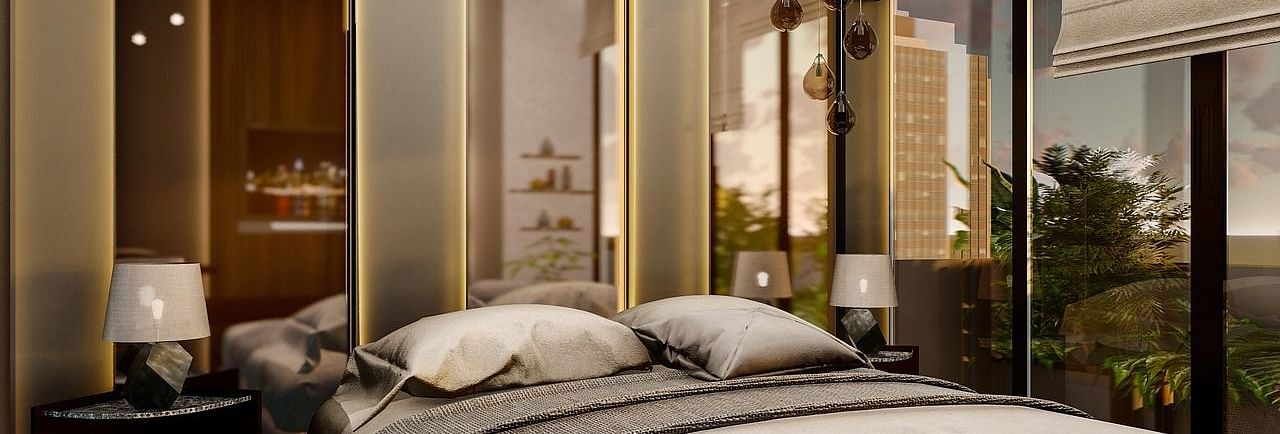 A room with chic and modern interiors with tall mirrors behind the bed.