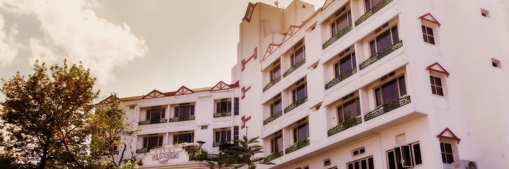 the exterior facade with white clouds in the background - Polo Towers hotel in Shillong