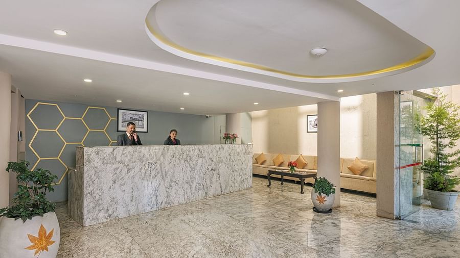 Stylish hotel lobby with modern furniture and marble floors | Mango HIll Central, Ooty