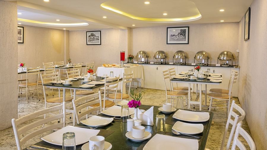 Elegant restaurant interior with buffet tables and decorative lighting | Mango HIll Central, Ooty