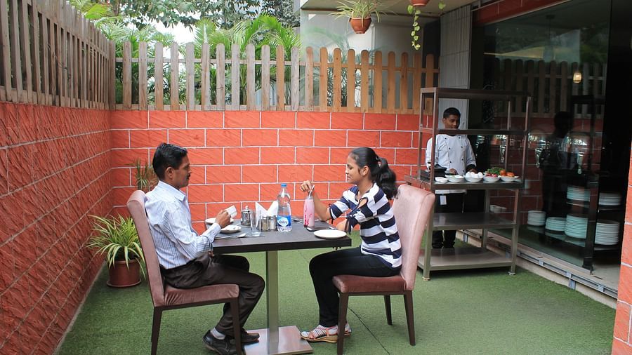 alt-text Two people dining and chatting