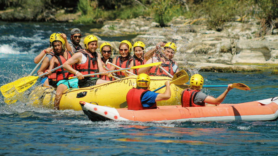 Group of people rafting on a boating on the river.