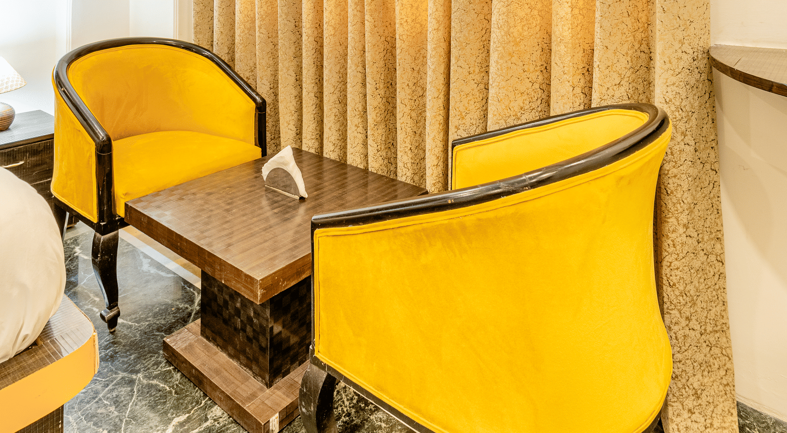 Two chairs facing each other in the superior double or twin room at Lime Tree Hotels and Banquet Hall Near Huda Metro, Gurgaon