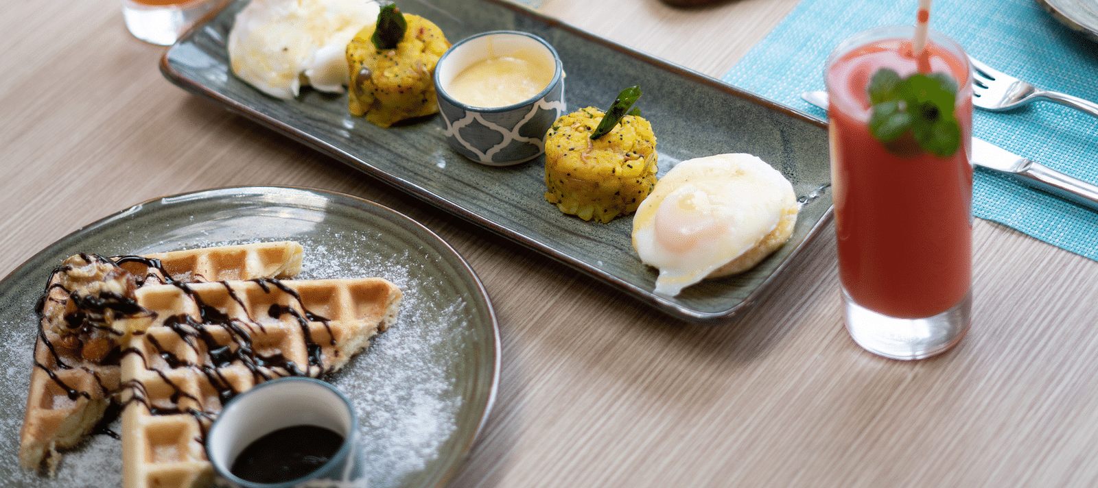 Waffles, fruit slices, and assorted desserts displayed on a plate at BluSalzz Escapade Resort, Lansdowne.