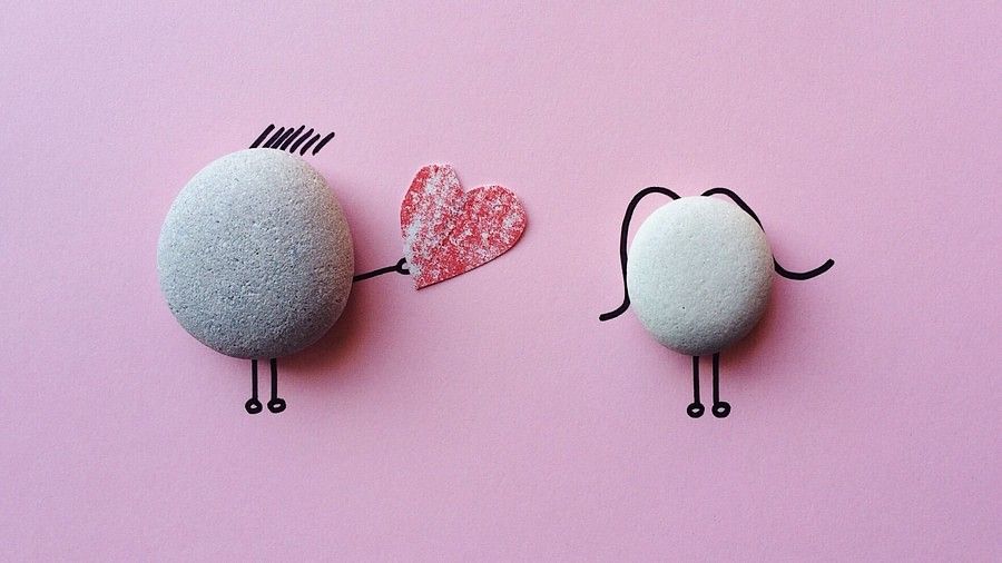 a caricature of two pebbles where one confesses its love to the other