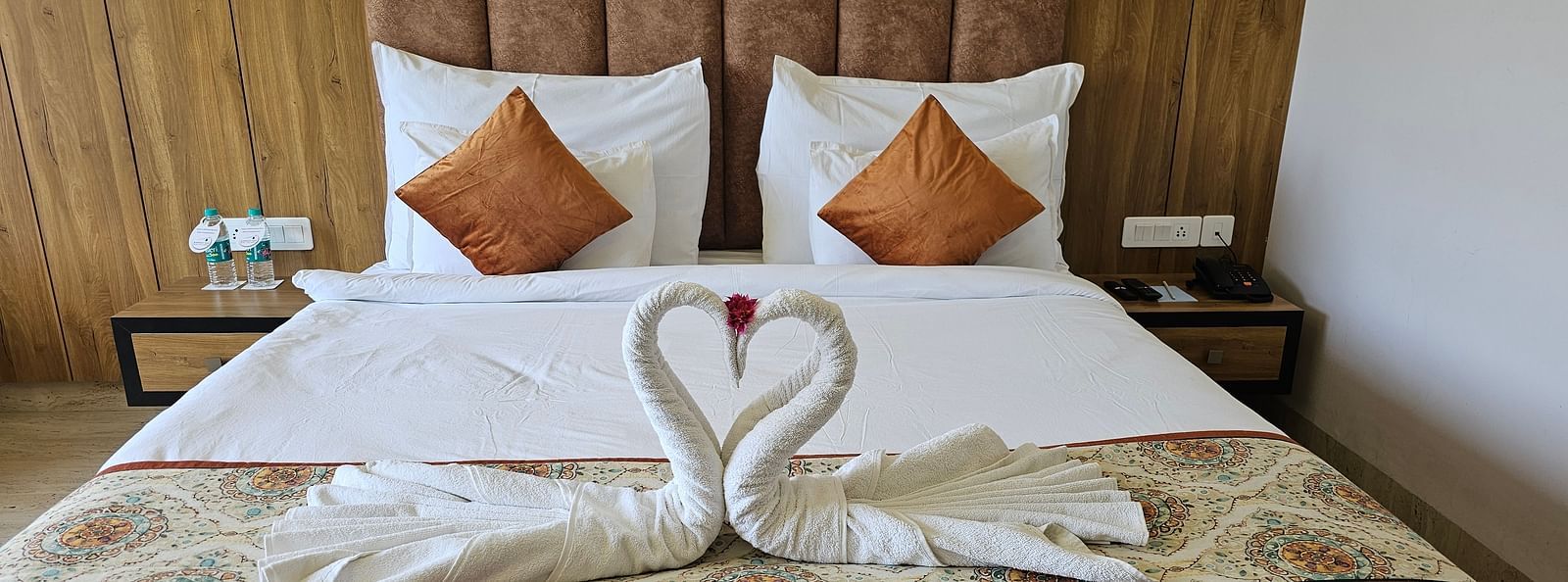 A neatly made bed in a room with white linens and decorative pillows - Bamboo Saa Mulberry Resort, Pushkar