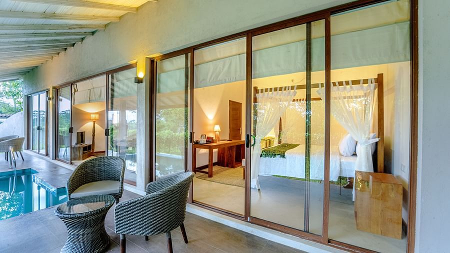 Poolside seating area with large glass windows
