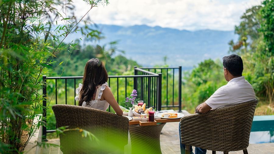 A couple having a good time eating food and wathcing the nature