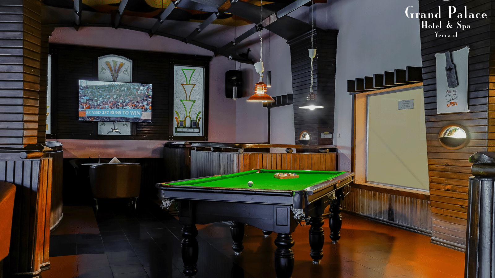 Cloud-9 Bar at Grand Palace, Yercaud featuring billiards table, projector screen, seating booths, and wooden interiors.
