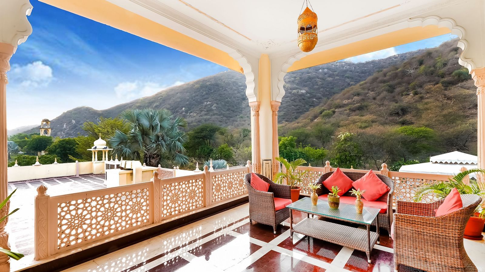 Seating arrangement in the balcony with hills in the background - Rajasthali Resort & Spa, Jaipur.