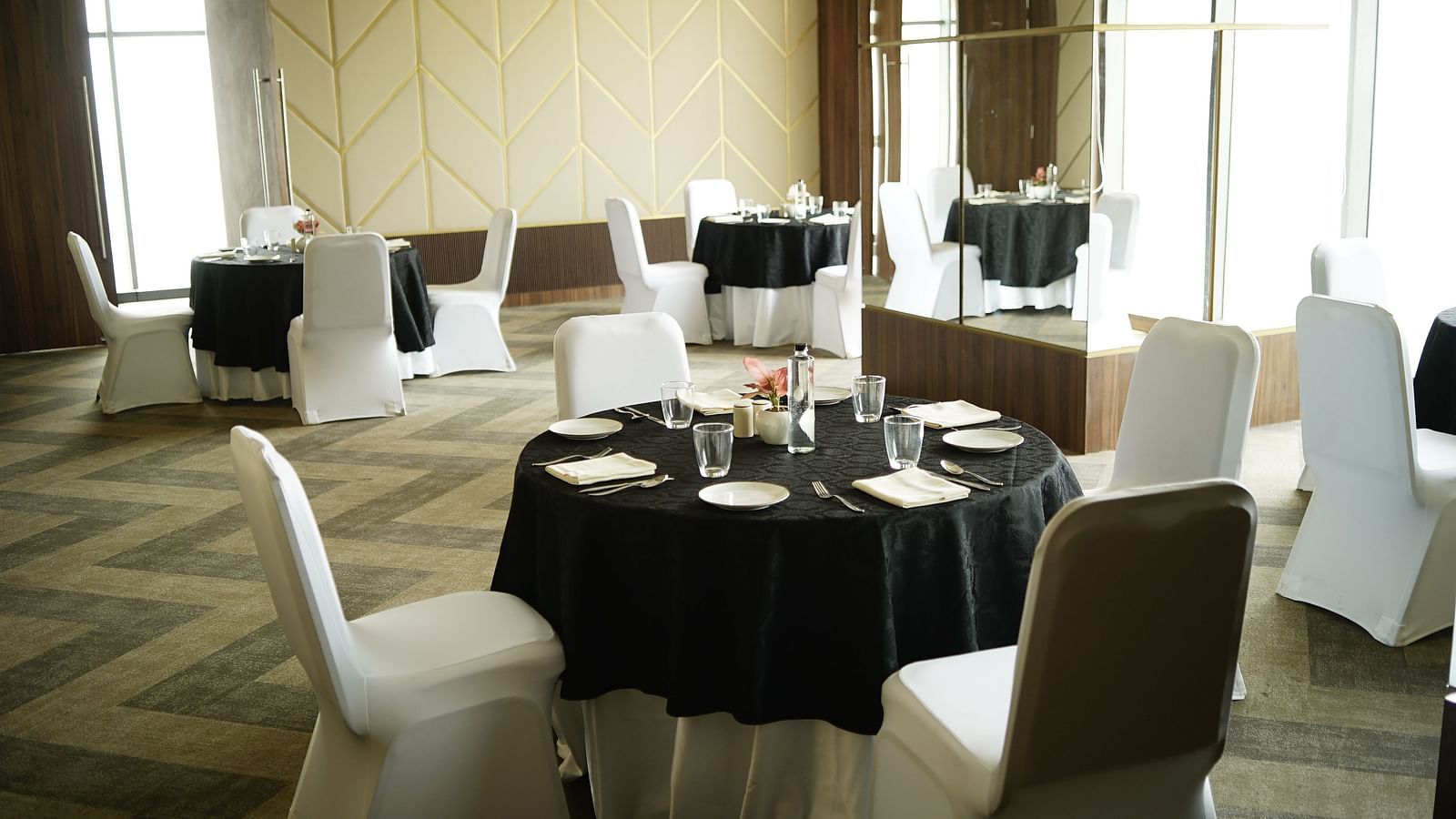 An overview of an event hall with round table seating arrangement - Rhythm Gurugram.