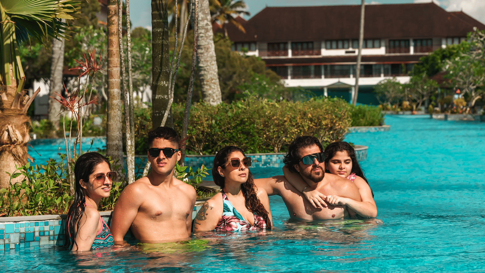 an image of a group of people in pool posing for a picture - Rhythm Kumarakom