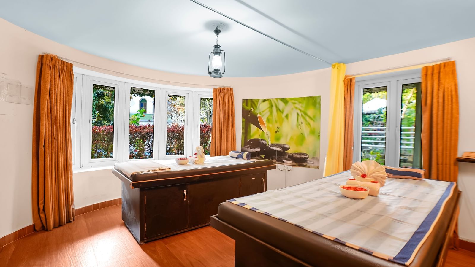 Full view of the spa room with massage tables and window curtains pulled to the side at WOW Bungalow, Yercaud.