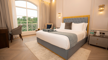 Spacious elegant hotel rooms in North Goa at MIROS Hotels featuring a king size bed and warm natural lighting