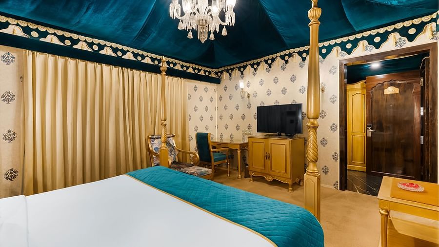 An overview of a tent with a close up shot of the double bed and a tv in the distance - Rajasthali Resort & Spa, Jaipur.