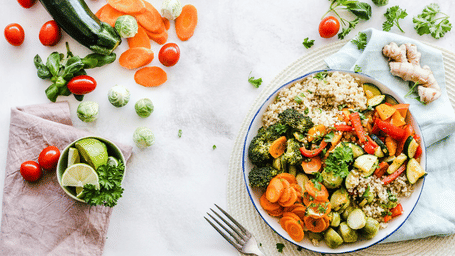 Salad bowl with vegetables, fork and napkins
