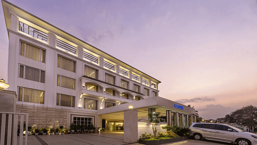 The exterior of the TGI Grand Fortuna Hotel during twilight, showcasing its entrance and facade - TGI Grand Fortuna, Hosur