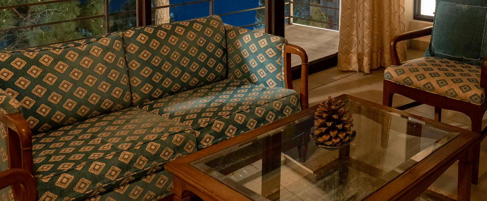 A suite living room featuring sofas, a table, and a glass window in the background at BluSalzz Escapade Resort, Lansdowne