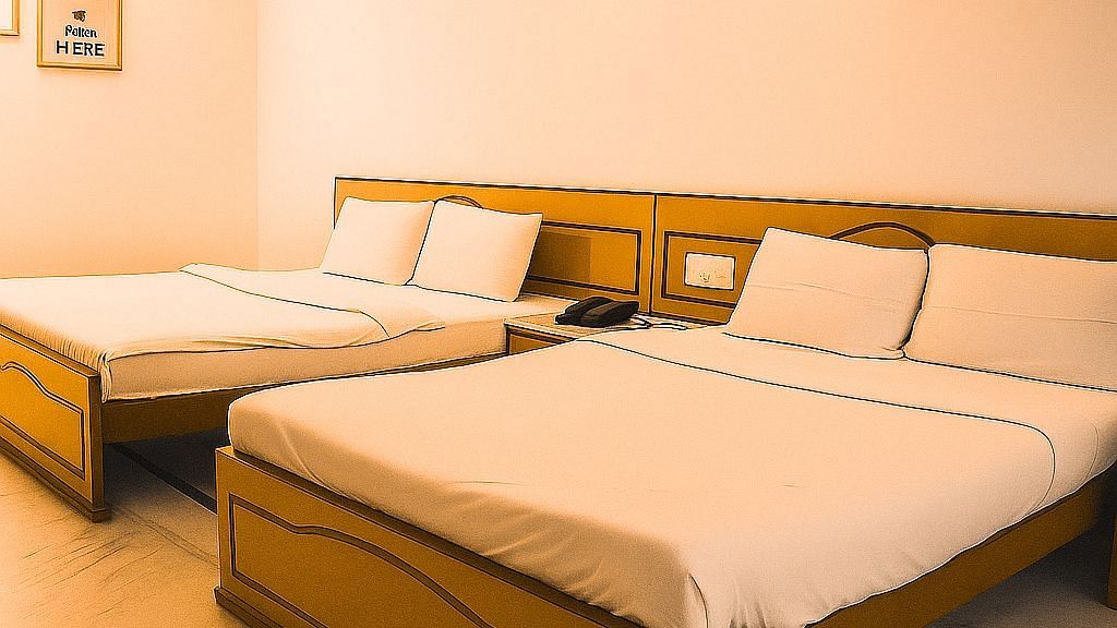 Deluxe Family Room at Ecotel Vinayak, Siliguri showcasing spacious triple beds, warm lighting, and comfortable family-friendly setting.