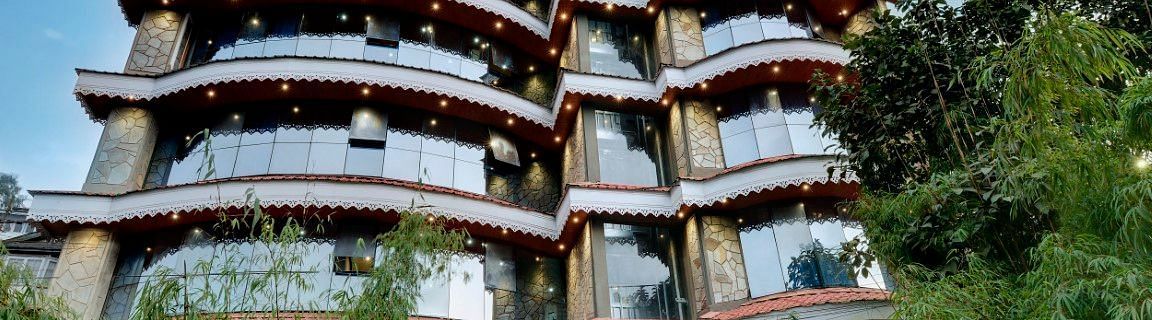 Facade image of Sumitel Queensyard building with greenery around