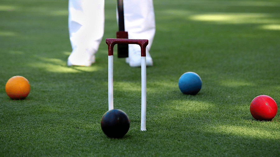A person prepares to play a game of croquet - Rhythm Lonavala
