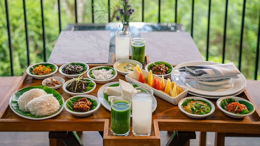 Dining table with a variety of dishes and a scenic backdrop