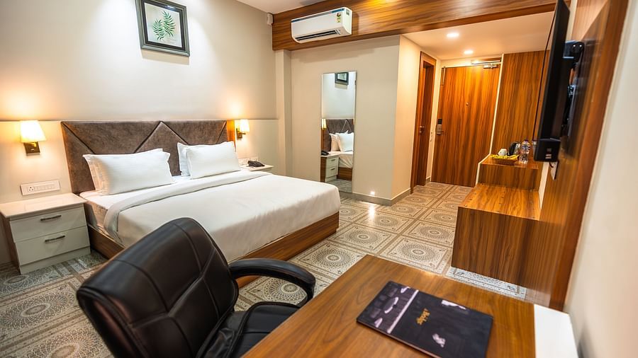 deluxe room with study table and chair and bed